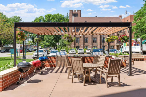 a patio with a table and chairs and a pergola