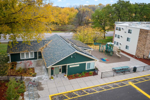 an aerial view of a building with a green house and a playground