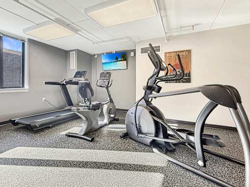 A gym with treadmills and exercise bikes.