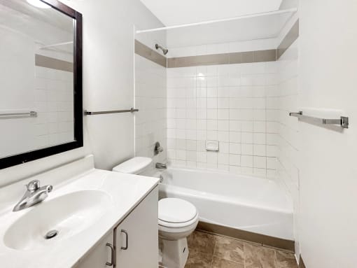 a bathroom with a sink toilet and a bath tub