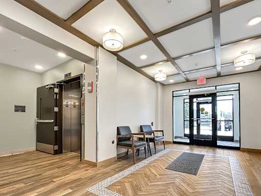 A room with a wooden floor and a black door.