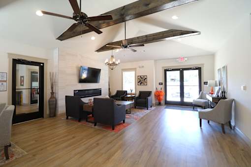 A living room with a fireplace and a television.