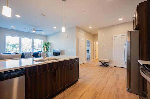 A modern kitchen with wooden cabinets and stainless steel appliances.