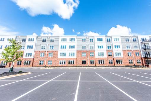 A large building with a parking lot in front of it.