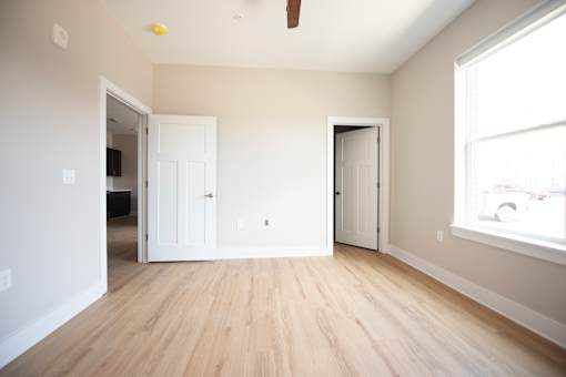 A room with a wooden floor and white walls.