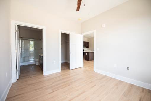 A room with a white wall and a wooden floor.