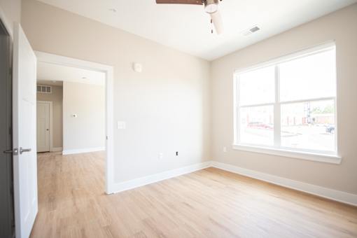 A room with a window and a door.