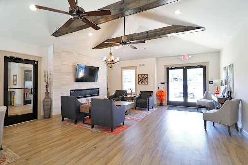 A living room with a fireplace and a television.