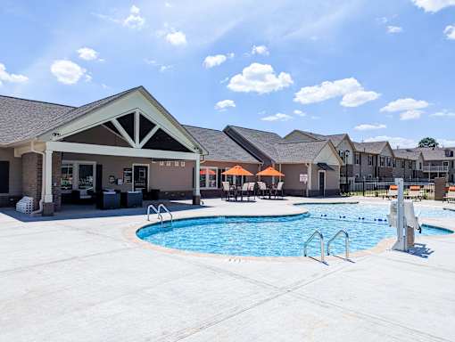 A pool area with a building in the background.