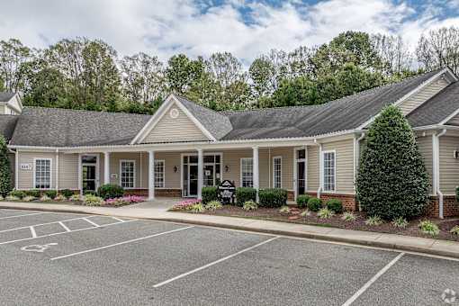A building with a parking lot in front of it.