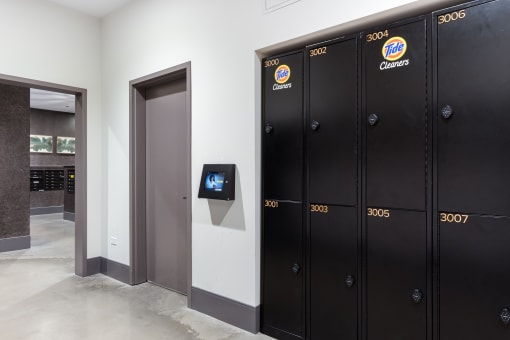 a row of lockers in a hallway with a television on the wall