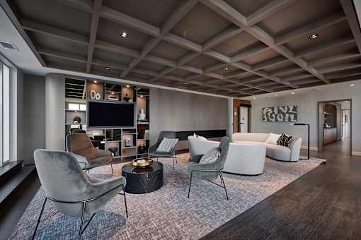 a living room with couches and chairs and a television