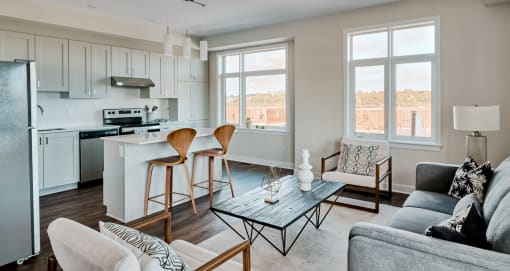 a living room with a kitchen and a couch and a table