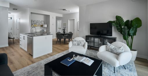 a living room with white furniture and a black coffee table