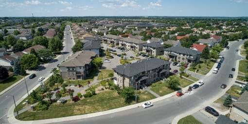 an aerial view of a neighborhood with houses and a street