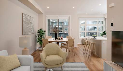 a living room and dining room with a table and chairs