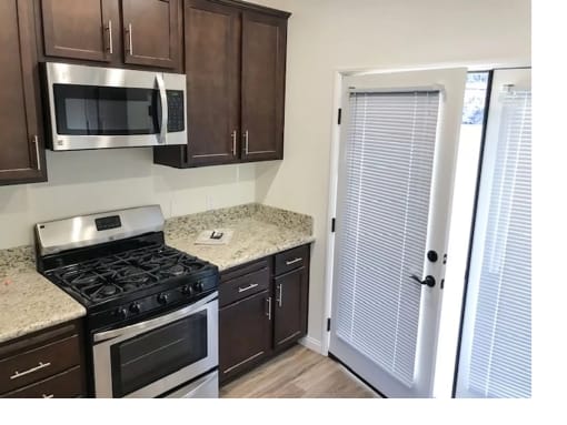 a kitchen with a stove and a microwave and a refrigerator