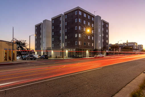 A long exposure shot of a street with a building in the background.