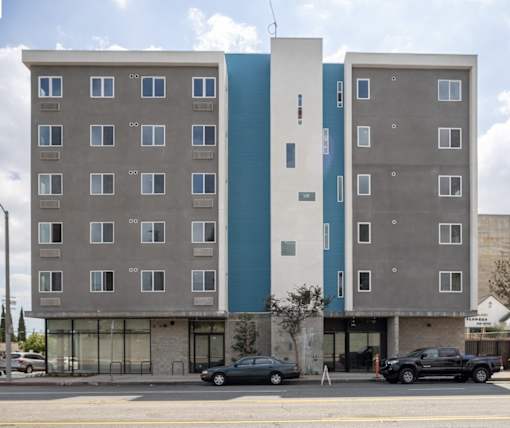 A modern building with a blue and white section on the side.