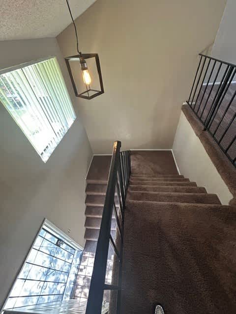 A staircase with a light hanging from the ceiling.