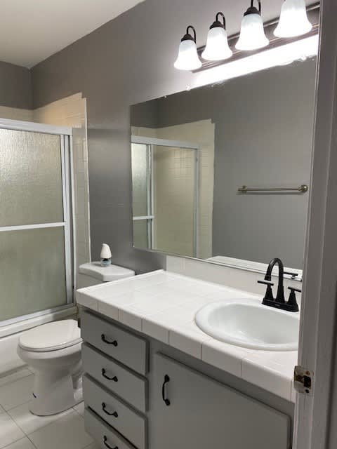 a bathroom with a sink toilet and a mirror