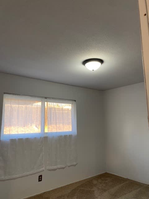 a room with a window and a light on the ceiling