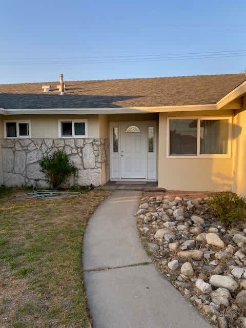 a house with a sidewalk and a white door