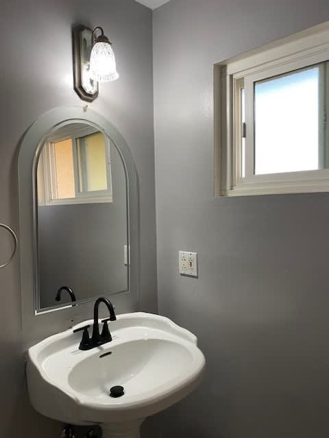 a bathroom with a white sink and a mirror