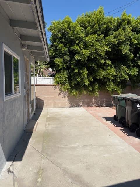 A tree is in front of a house.