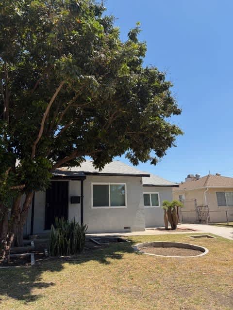 A house with a tree in front of it.