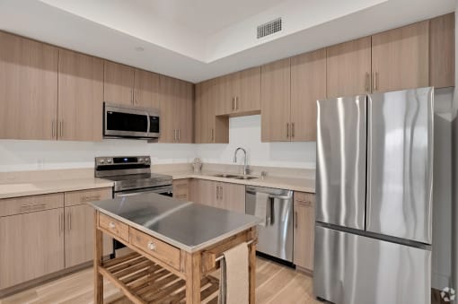 a kitchen with stainless steel appliances and wooden cabinets