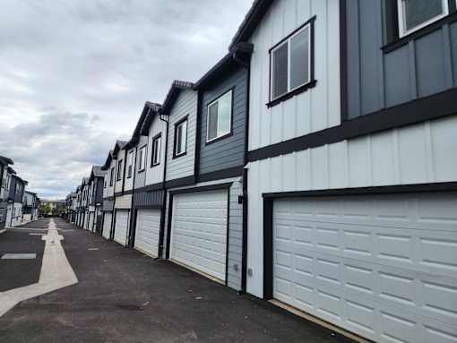 A long row of houses with garages.