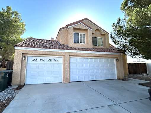 A house with a white garage door is shown.