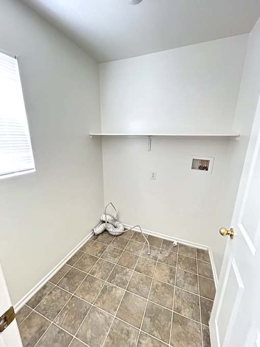 A room with a tile floor and a door.