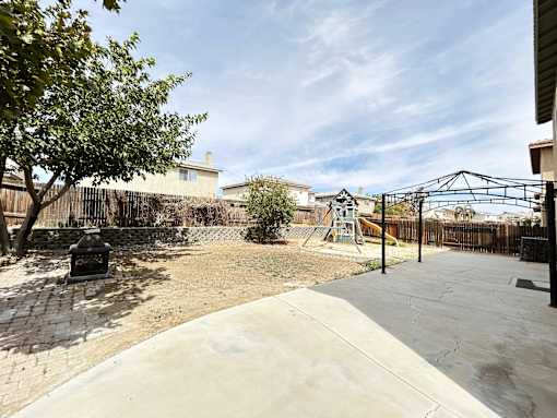 A backyard with a playground and a slide.