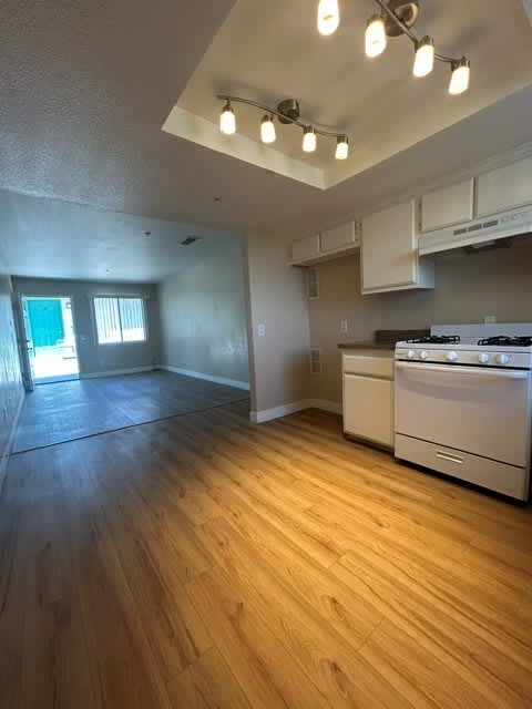 A kitchen with a stove top oven and a window.