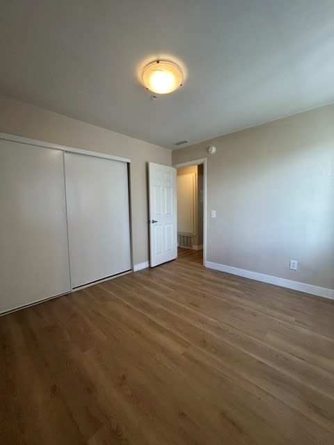 A room with a white door and a white wall.