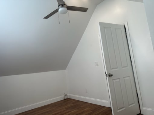 a bedroom with a white door and a ceiling fan