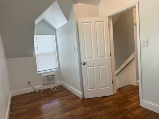 an empty room with a door and a window