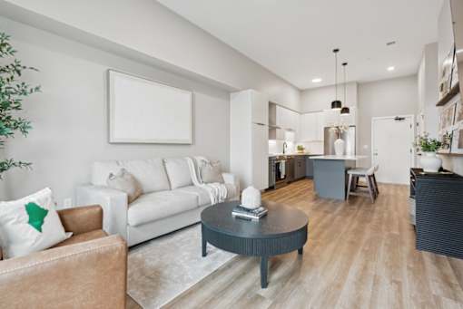 A modern living room with a brown leather couch and a white sofa.