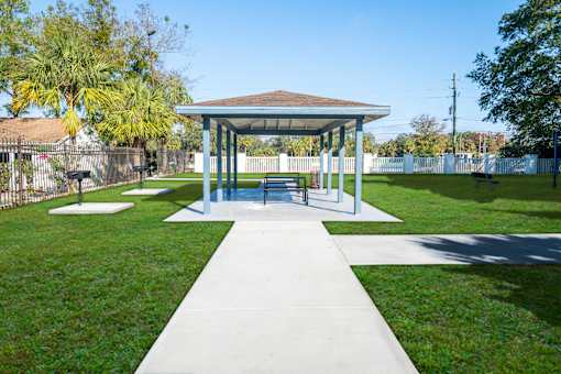 A pavilion with a white walkway in front of it. at Red Bay Apartment Complex, Jacksonville, FL, 32211