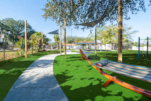 A park with a hammock between two trees. at Red Bay Apartment Complex, Jacksonville, FL, 32211