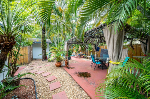 a backyard with a patio and palm trees