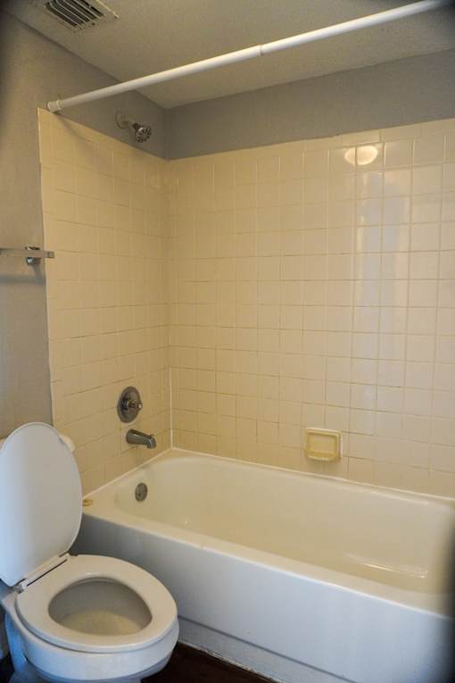 a bathroom with a toilet and a bath tub  at Bella Lago Vista, Florida, 33401