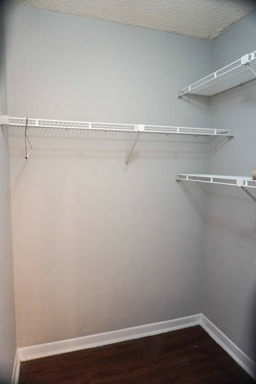 a walk in closet with two shelves and a wooden floor  at Bella Lago Vista, West Palm Beach, FL, 33401