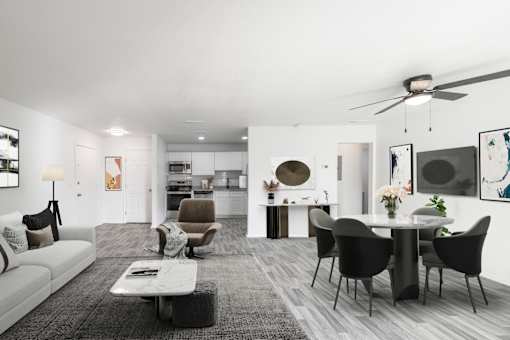 A modern living room with a grey carpet and a white sofa. at Red Bay Apartment Complex, Jacksonville, FL, 32211