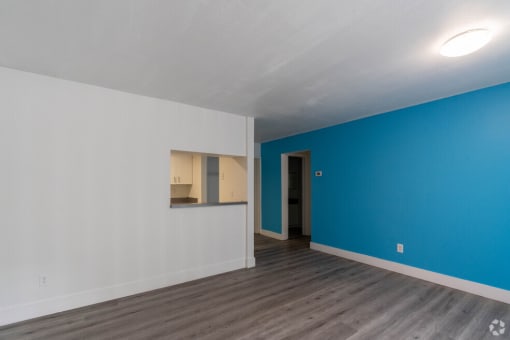 a bedroom with a blue wall and white walls at Red Bay Apartment Complex, Florida