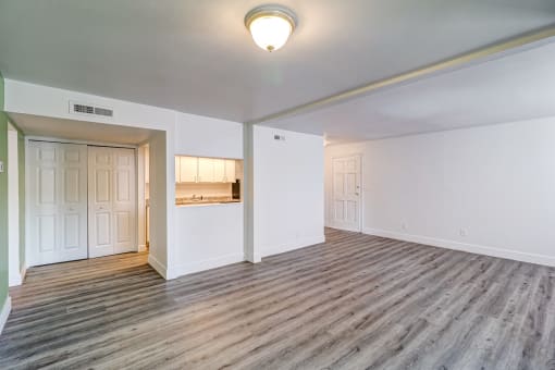 a living room with hardwood floors and white walls at Red Bay Apartment Complex, Jacksonville, Florida