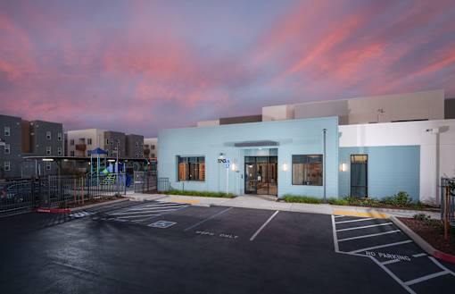 the exterior of a building with a parking lot