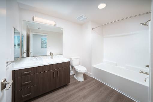 a bathroom with a toilet and a tub and a sink